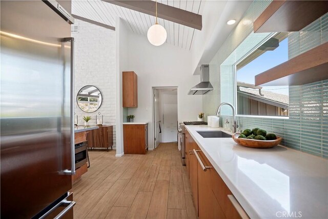 1987 Windover Rd, Pasadena, CA 91107 - kitchen featuring high quality appliances, wall chimney range hood, brown cabinetry, beamed ceiling, and light wood-type flooring