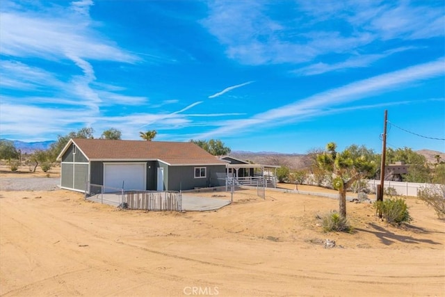 7167 Sunny Vista Rd, Joshua Tree, CA 92252 - rear view of house with a mountain view and an attached garage