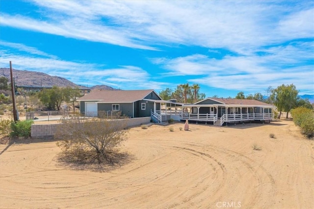 7167 Sunny Vista Rd, Joshua Tree, CA 92252 - ranch-style house featuring an attached garage and a deck with mountain view