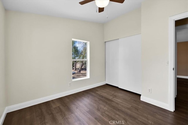 7167 Sunny Vista Rd, Joshua Tree, CA 92252 - unfurnished bedroom with dark wood finished floors, a closet, and a ceiling fan
