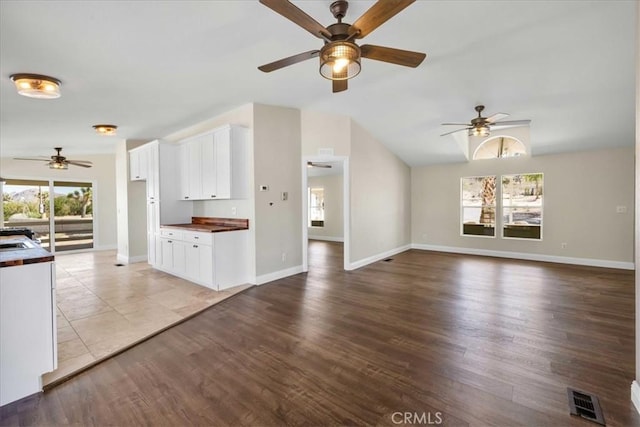 7167 Sunny Vista Rd, Joshua Tree, CA 92252 - unfurnished living room with a ceiling fan, lofted ceiling, and light wood-type flooring