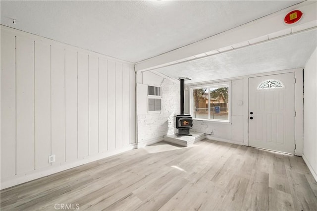 44668 Brawley Ave, Jacumba, CA 91934 - entryway featuring a wood stove, wood finished floors, and a textured ceiling