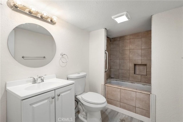 44668 Brawley Ave, Jacumba, CA 91934 - full bathroom featuring vanity, tiled shower / bath, a textured ceiling, and wood finished floors