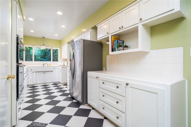1525 Lafayette Rd, Claremont, CA 91711 - kitchen with light flooring, appliances with stainless steel finishes, white cabinets, light countertops, and backsplash