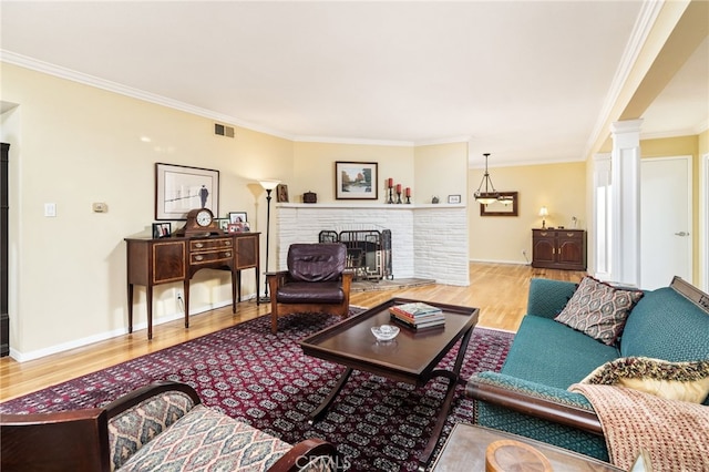1525 Lafayette Rd, Claremont, CA 91711 - living room featuring wood finished floors, ornamental molding, decorative columns, and a fireplace