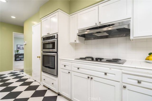 1525 Lafayette Rd, Claremont, CA 91711 - kitchen featuring light flooring, appliances with stainless steel finishes, under cabinet range hood, tile countertops, and white cabinets