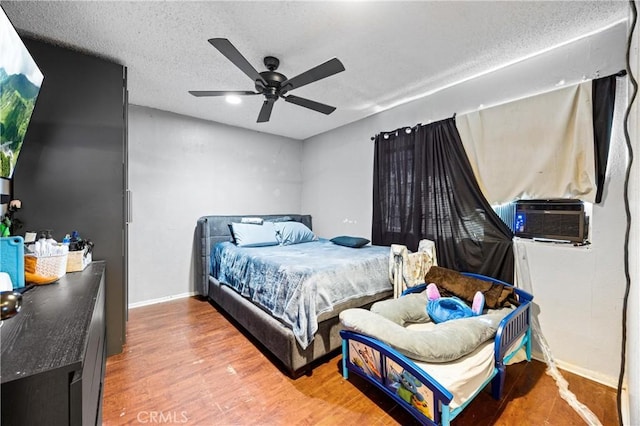 6362 Darlington Ave, Buena Park, CA 90621 - bedroom featuring wood finished floors, cooling unit, a textured ceiling, and a ceiling fan