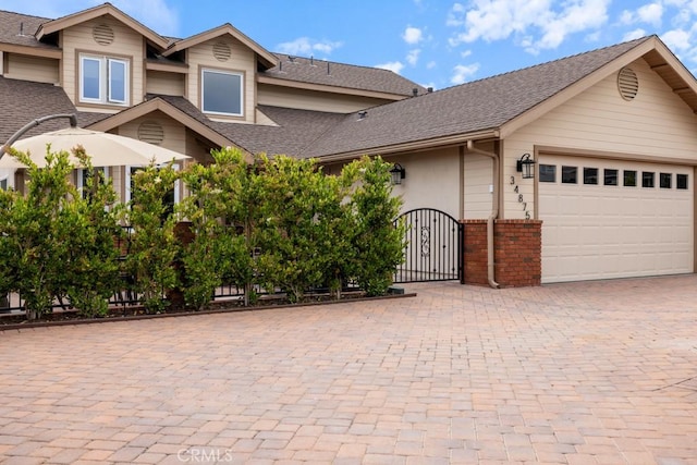 34875 Calle Del Sol, Dana Point, CA 92624 - multi unit property featuring an attached garage, decorative driveway, roof with shingles, and brick siding