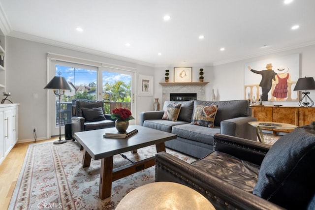 34875 Calle Del Sol, Dana Point, CA 92624 - living room featuring light wood-type flooring, recessed lighting, a glass covered fireplace, and crown molding