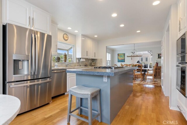 34875 Calle Del Sol, Dana Point, CA 92624 - kitchen featuring stainless steel appliances, white cabinetry, light wood-style floors, a center island, and recessed lighting