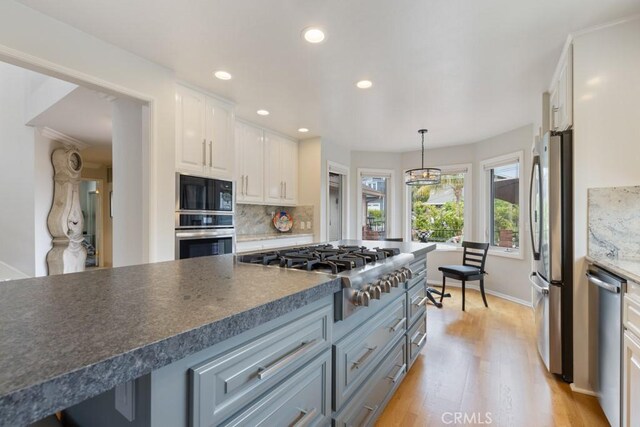 34875 Calle Del Sol, Dana Point, CA 92624 - kitchen with stainless steel appliances, white cabinets, light wood-style floors, decorative backsplash, and recessed lighting