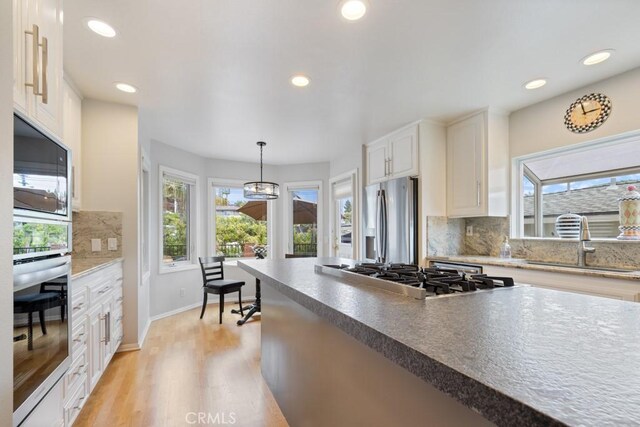 34875 Calle Del Sol, Dana Point, CA 92624 - kitchen featuring appliances with stainless steel finishes, healthy amount of natural light, backsplash, recessed lighting, and white cabinetry
