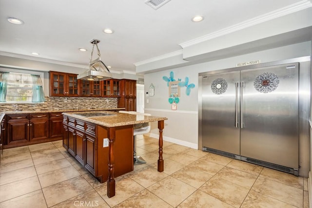 748 S Walnut Ave, San Dimas, CA 91773 - kitchen featuring built in refrigerator, ornamental molding, stovetop, a breakfast bar, and backsplash