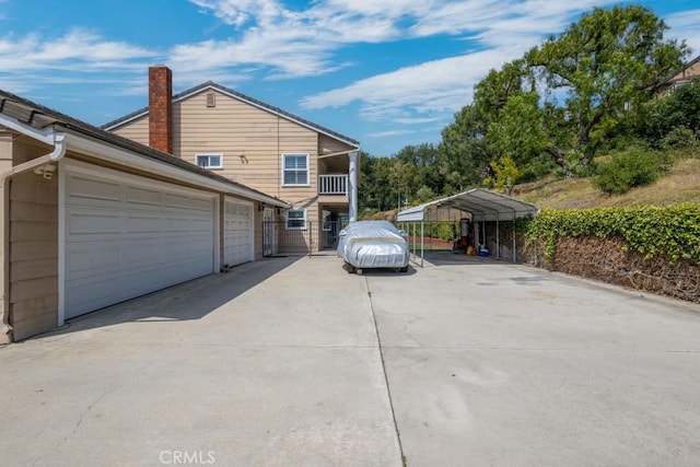 748 S Walnut Ave, San Dimas, CA 91773 - view of side of property with a chimney, driveway, a garage, and a detached carport