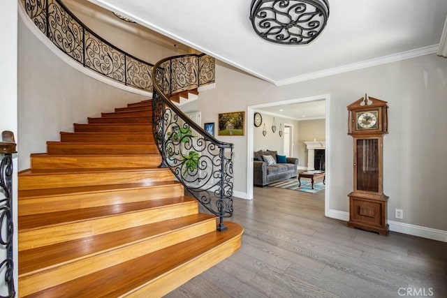 748 S Walnut Ave, San Dimas, CA 91773 - staircase featuring crown molding, wood finished floors, and a fireplace