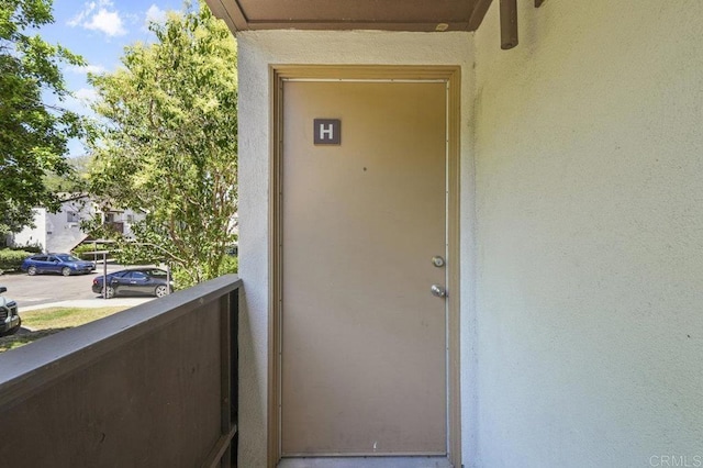 1317 Caminito Gabaldon Unit H, San Diego, CA 92108 - property entrance featuring a balcony and stucco siding