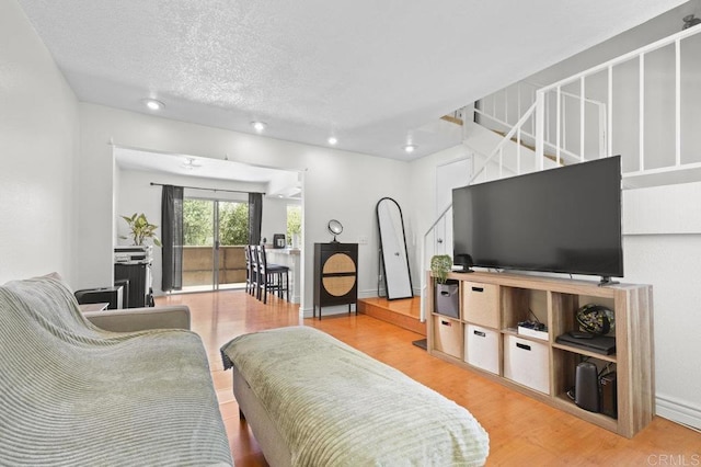1317 Caminito Gabaldon Unit H, San Diego, CA 92108 - living room with wood finished floors, a textured ceiling, stairway, and recessed lighting
