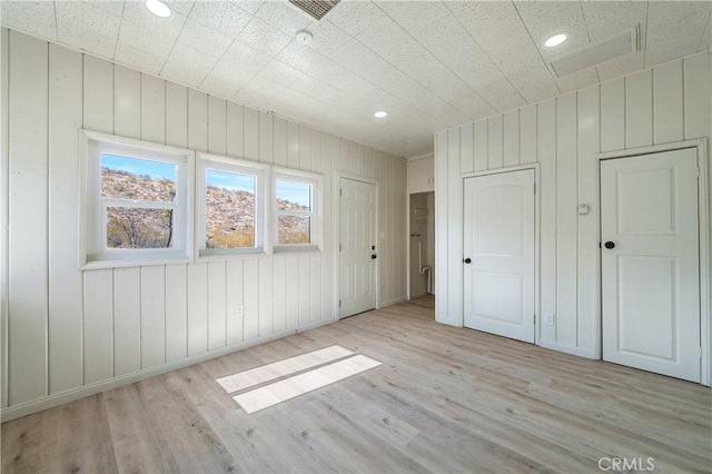 7888 Victor, Yucca Valley, CA 92284 - unfurnished bedroom featuring wood finished floors, recessed lighting, and wood walls