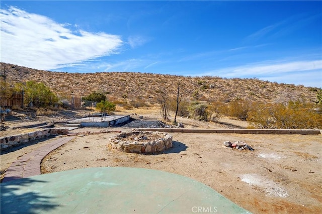 7888 Victor, Yucca Valley, CA 92284 - view of yard featuring a mountain view and an outdoor fire pit