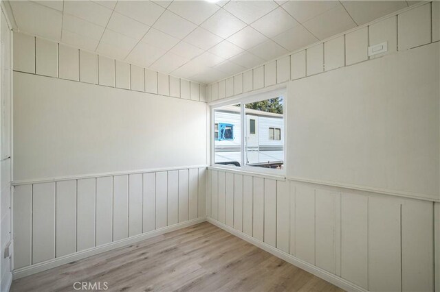 7888 Victor, Yucca Valley, CA 92284 - unfurnished room featuring wood finished floors and a wainscoted wall