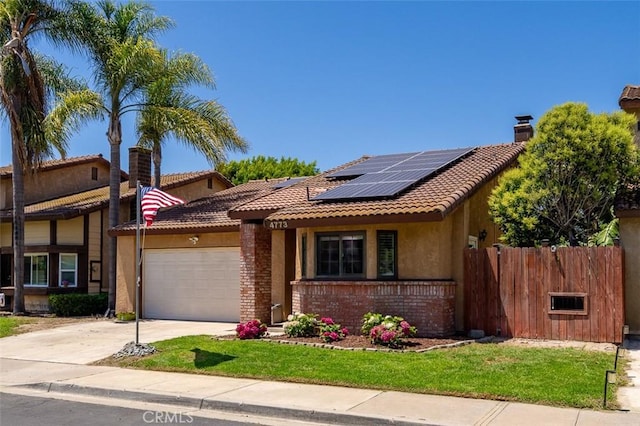 4773 Adler, Oceanside, CA 92057 - view of front facade featuring brick siding, a tiled roof, a garage, solar panels, and stucco siding