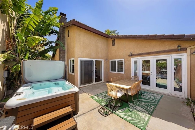 4773 Adler, Oceanside, CA 92057 - rear view of property featuring a hot tub, a patio area, stucco siding, a chimney, and french doors