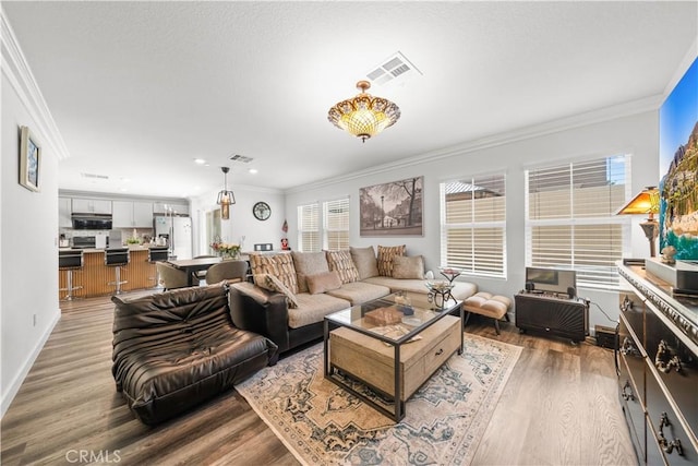 9804 Ardisia St, Riverside, CA 92503 - living area with crown molding, wood finished floors, and recessed lighting