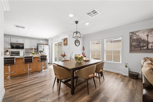 9804 Ardisia St, Riverside, CA 92503 - dining space featuring ornamental molding, light wood-type flooring, and recessed lighting