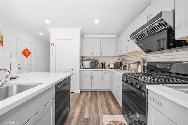 9804 Ardisia St, Riverside, CA 92503 - kitchen featuring black appliances, extractor fan, ornamental molding, tasteful backsplash, and light countertops
