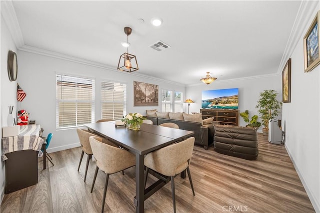 9804 Ardisia St, Riverside, CA 92503 - dining room featuring wood finished floors and ornamental molding