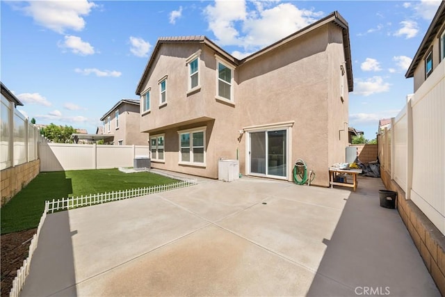 9804 Ardisia St, Riverside, CA 92503 - back of house featuring stucco siding, a fenced backyard, and a patio area
