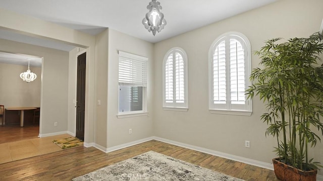 32420 Apricot Tree Rd, Winchester, CA 92596 - spare room featuring a chandelier, healthy amount of natural light, and wood finished floors