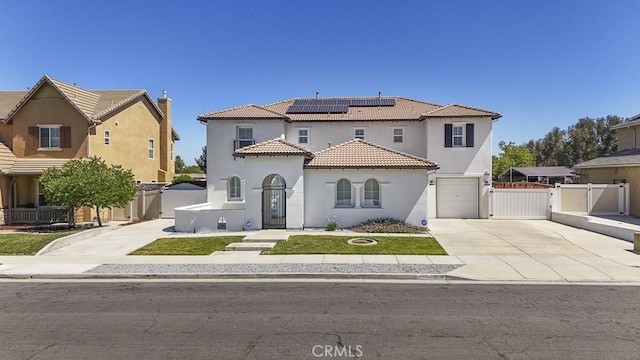 32420 Apricot Tree Rd, Winchester, CA 92596 - mediterranean / spanish home featuring a gate, concrete driveway, roof mounted solar panels, and stucco siding