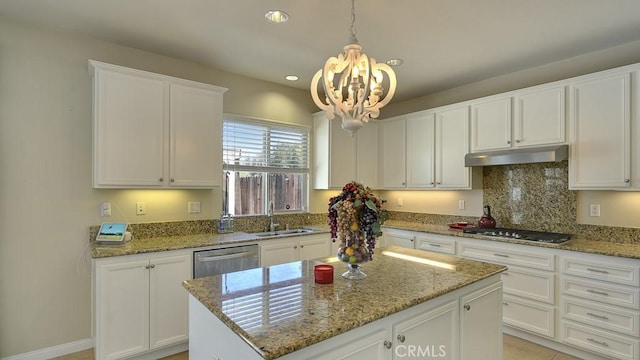 32420 Apricot Tree Rd, Winchester, CA 92596 - kitchen with under cabinet range hood, appliances with stainless steel finishes, a chandelier, white cabinets, and light stone counters