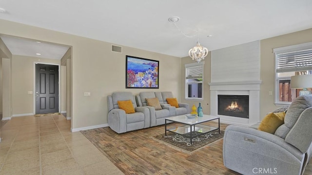 32420 Apricot Tree Rd, Winchester, CA 92596 - living room with a fireplace, a chandelier, light tile patterned flooring, and recessed lighting