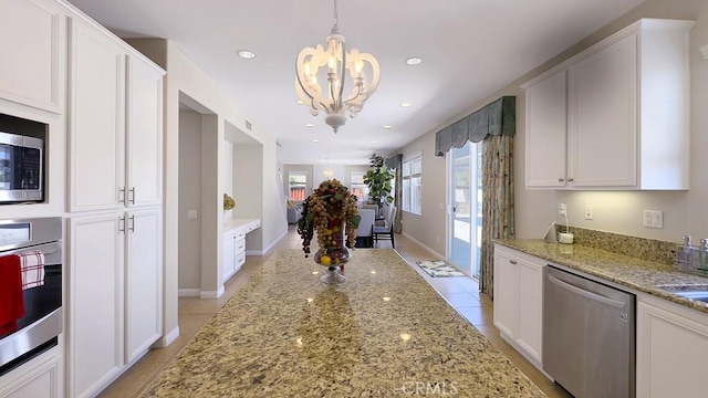 32420 Apricot Tree Rd, Winchester, CA 92596 - kitchen with appliances with stainless steel finishes, light tile patterned floors, a chandelier, white cabinetry, and light stone counters