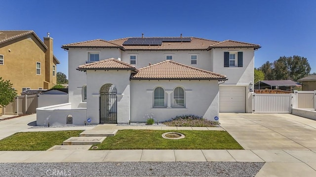 32420 Apricot Tree Rd, Winchester, CA 92596 - mediterranean / spanish home with a gate, roof mounted solar panels, concrete driveway, stucco siding, and an attached garage