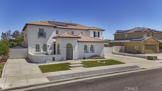 32420 Apricot Tree Rd, Winchester, CA 92596 - mediterranean / spanish house featuring a gate, driveway, stucco siding, and solar panels