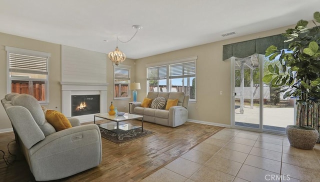 32420 Apricot Tree Rd, Winchester, CA 92596 - living room with a chandelier, a glass covered fireplace, and wood finished floors