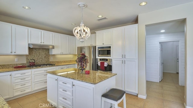 32420 Apricot Tree Rd, Winchester, CA 92596 - kitchen with stainless steel appliances, under cabinet range hood, light tile patterned floors, a chandelier, and recessed lighting