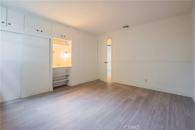 1725 Turnbull Canyon Rd, Hacienda Heights, CA 91745 - unfurnished bedroom with wood finished floors and a closet