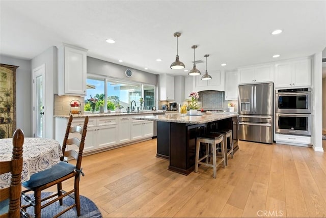 3526 Alder Pl, Chino Hills, CA 91709 - kitchen featuring stainless steel appliances, tasteful backsplash, white cabinetry, recessed lighting, and a kitchen island