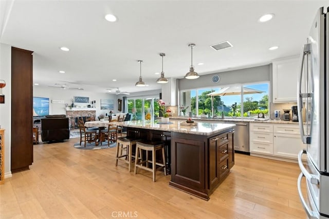3526 Alder Pl, Chino Hills, CA 91709 - kitchen featuring stainless steel appliances, ceiling fan, white cabinetry, open floor plan, and dark brown cabinets