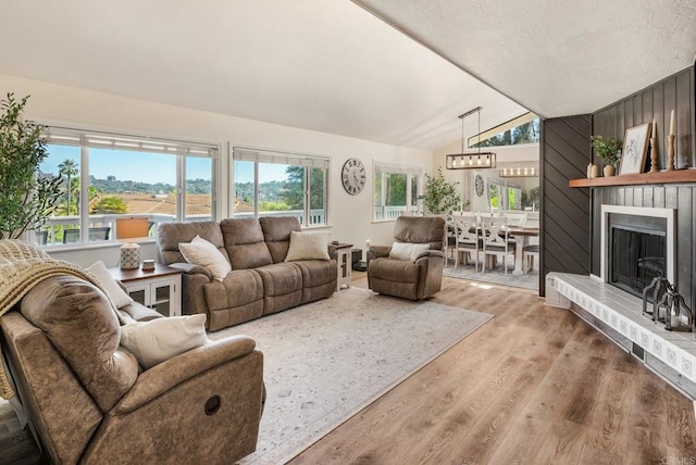 10518 Moon View Way, Escondido, CA 92026 - living room with vaulted ceiling, healthy amount of natural light, wood finished floors, and a large fireplace
