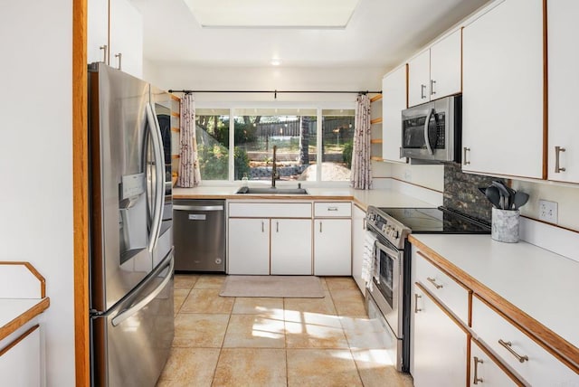 10518 Moon View Way, Escondido, CA 92026 - kitchen featuring appliances with stainless steel finishes, white cabinetry, light countertops, and backsplash