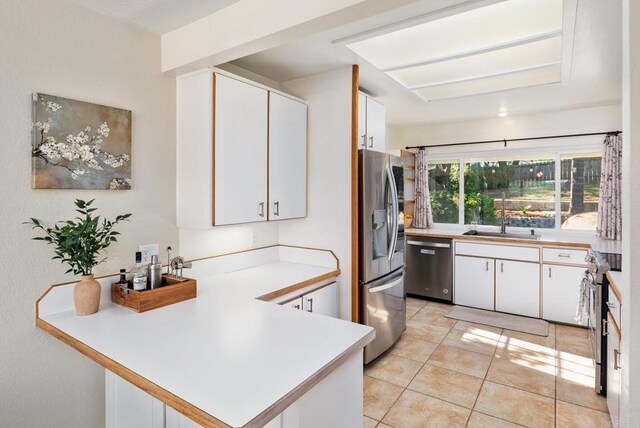10518 Moon View Way, Escondido, CA 92026 - kitchen with appliances with stainless steel finishes, a peninsula, white cabinets, and light countertops