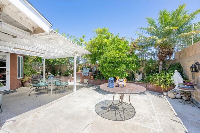 9909 Merced River Ave, Fountain Valley, CA 92708 - fenced backyard with outdoor dining space, area for grilling, a pergola, and a patio