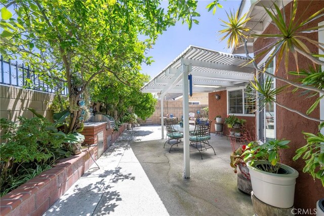 9909 Merced River Ave, Fountain Valley, CA 92708 - fenced backyard with area for grilling, a pergola, outdoor dining space, and a patio