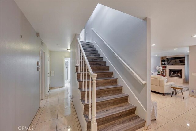 9909 Merced River Ave, Fountain Valley, CA 92708 - stairway featuring tile patterned flooring, a tiled fireplace, and recessed lighting