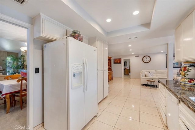 9909 Merced River Ave, Fountain Valley, CA 92708 - kitchen with white appliances, open floor plan, white cabinetry, light tile patterned floors, and dark stone countertops